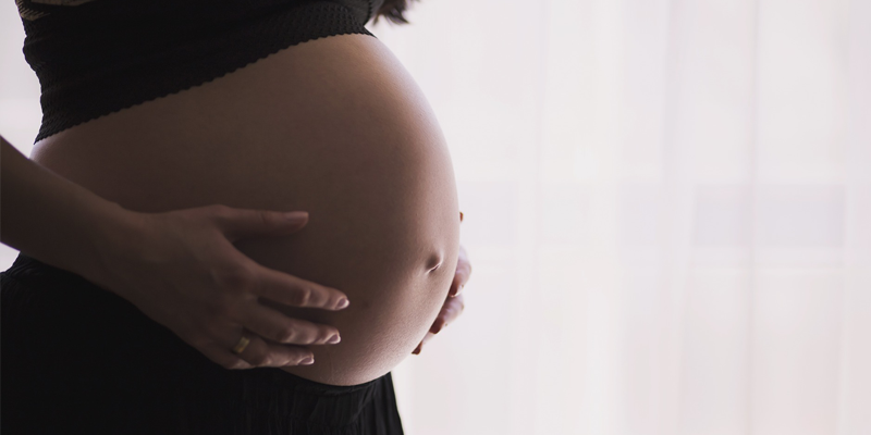 Diastasis Recti Blog - Image of a Women Holding her stomach during her pregnancy